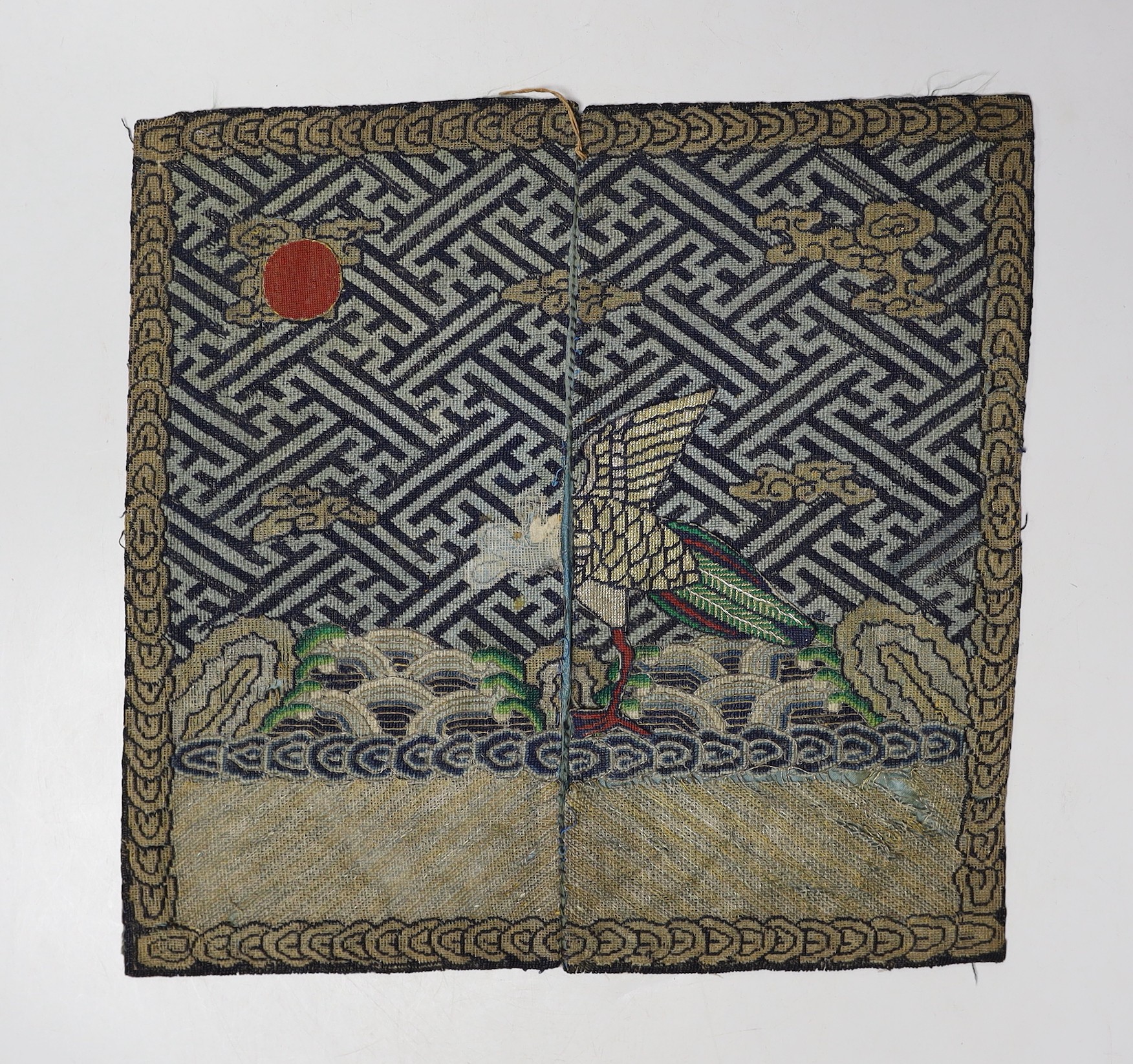 A Chinese rank badge, finely embroidered in multi coloured silks and gold thread, with an appliquéd phoenix, (a.f) 29x30cm